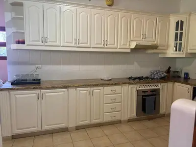 a kitchen with white cabinets and a counter top at Casa de Campo Golf, Villa La Romana in La Romana