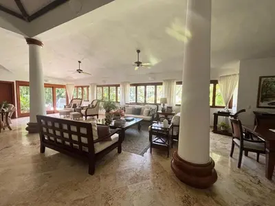 a living room with columns and a couch and chairs at Casa de Campo Golf, Villa La Romana in La Romana
