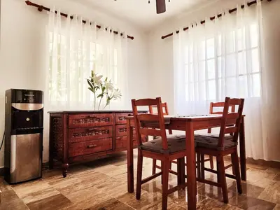 a dining room with a table and chairs and a refrigerator at Zen Apartment in Punta Cana