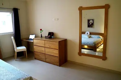a bedroom with a mirror and a dresser and a bed at Luxury Apartment close to centre of Jarabacoa in Jarabacoa