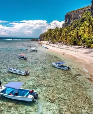a group of boats in the water on a beach at Habitacion 2 en Dani's Guest House in Las Galeras
