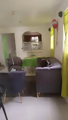 a living room with two couches and a green table at Queen Bmazazhi Stay in San Pedro de Macorís