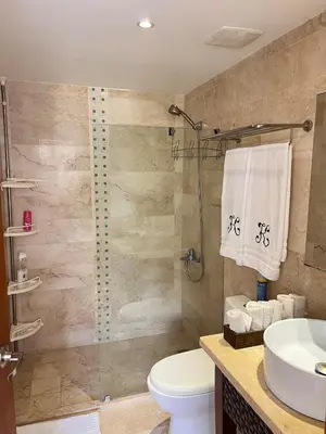 a bathroom with a shower and a toilet and a sink at Beautiful apartment in Playa Dorada in San Felipe de Puerto Plata