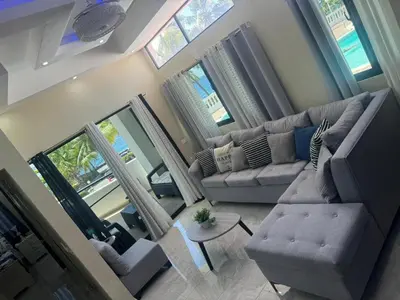 an overhead view of a living room with a couch and chairs at Costa Azul Skibel 2 br in Santo Domingo