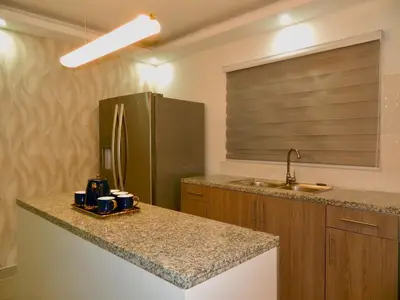 a kitchen with a counter top and a refrigerator at The Chic Hideout full apt in san isidro Terrace in Juan López