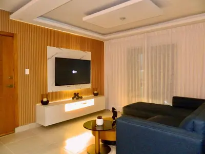 a living room with a couch and a tv at The Chic Hideout full apt in san isidro Terrace in Juan López