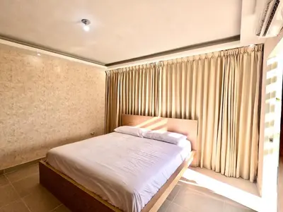 a bedroom with a bed and a window with curtains at The Chic Hideout full apt in san isidro Terrace in Juan López