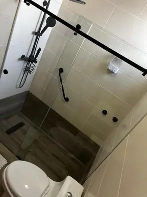 a bathroom with a toilet and a glass shower stall at Margarita 4toB in Marilópez
