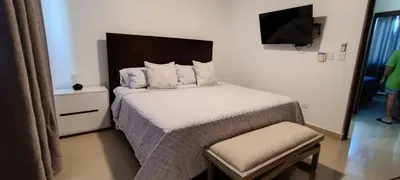 a small bedroom with a bed and a television at Margarita 4toB in Marilópez