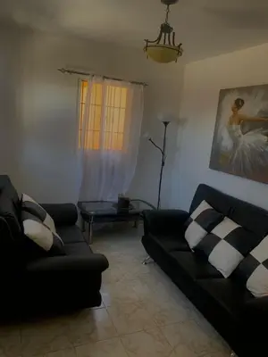 a living room with a couch and a table at Casa modesta para disfrutar in Colorado