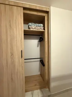 a wooden cupboard with a drawer in a room at Villa con piscina privada en Punta Cana in Punta Cana