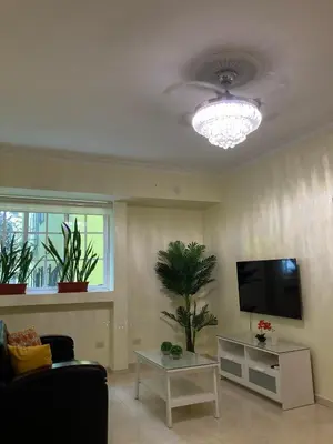 a living room with a flat screen tv and a couch at Residencial Don Pedro 1103 in Santo Domingo