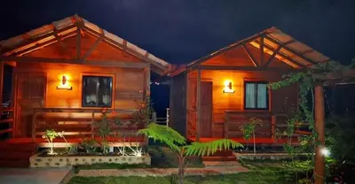 a small wooden house with lights on it at Ecocamping Aventura in Boca de Cana