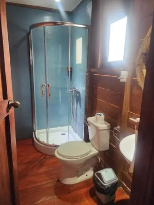 a bathroom with a shower and a toilet and a sink at Ecocamping Aventura in Boca de Cana