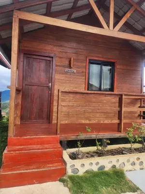 a wooden house with a wooden door and stairs at Ecocamping Aventura in Boca de Cana