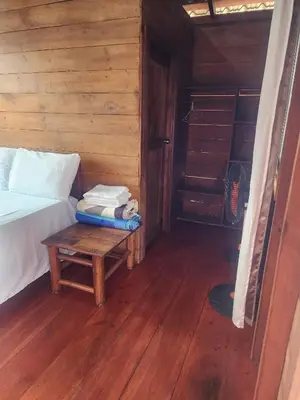 a bedroom with a bed and a table with towels at Ecocamping Aventura in Boca de Cana