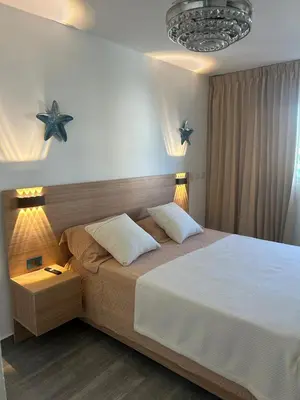 a bedroom with a large bed with two pillows at Tranquil 3 Bedroom Apartment - Pool & Private Beach Access in Punta Cana