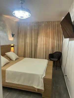 a bedroom with a bed and a desk and a television at Tranquil 3 Bedroom Apartment - Pool & Private Beach Access in Punta Cana