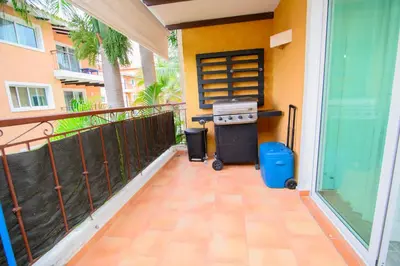 a grill on the balcony of a house at Tranquil 3 Bedroom Apartment - Pool & Private Beach Access in Punta Cana