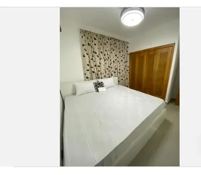 a bedroom with a large white bed in a room at Casa con jacuzzi in Santiago de los Caballeros