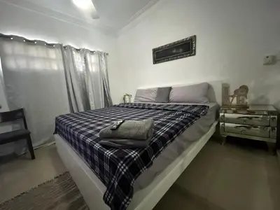 a bedroom with a bed with a purse on it at Casa con jacuzzi in Santiago de los Caballeros