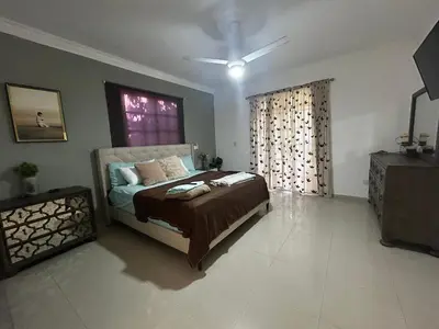 a bedroom with a bed and a window at Casa con jacuzzi in Santiago de los Caballeros