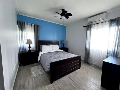 a bedroom with a bed and a ceiling fan at Jojo's Caribbean Retreat in Punta Cana