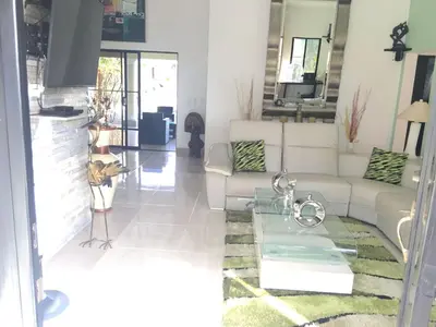 a living room with a couch and a table at Villa vacances de reve in Sosúa
