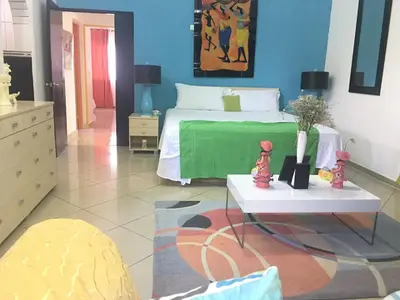 a bedroom with a bed with a green blanket at Villa vacances de reve in Sosúa