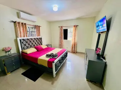 a bedroom with a large bed and a flat screen tv at Oasis de Paz 04 in Colorado