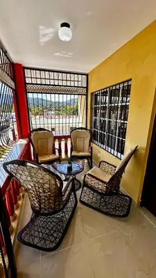 a living room with chairs and a table and windows at Oasis de Paz 04 in Colorado