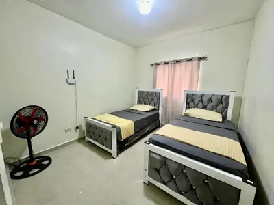 a bedroom with two beds and a chair in it at Oasis de Paz 04 in Colorado