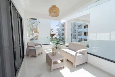 a living room with chairs and a table at Modern 1BR Retreat Central Bayahibe Sunshine in San Rafael del Yuma
