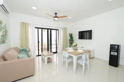 a living room with a table and a couch at Modern 1BR Retreat Central Bayahibe Sunshine in San Rafael del Yuma