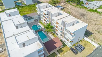 an aerial view of a white apartment building at Modern 1BR Retreat Central Bayahibe Sunshine in San Rafael del Yuma