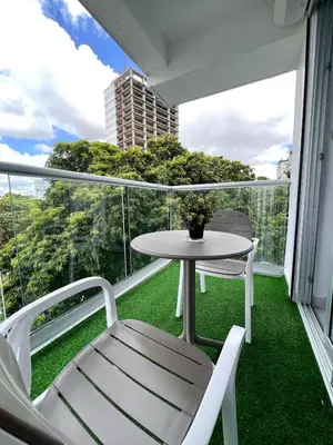 a patio with a table and chairs on a balcony at Comodo departamento centrico SD in Santo Domingo