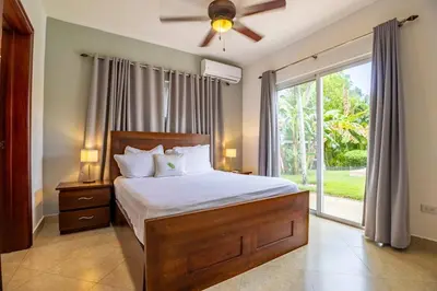 a bedroom with a bed and a large window at Casa Linda Villa 722 - Sosua - BBQ - Washer in Sosúa
