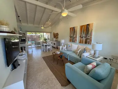 a living room with a blue couch and a tv at Juan Dolio House 2BR y Patio in Los Corrales