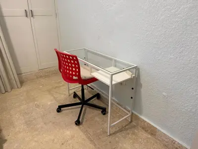 a red chair sitting in front of a desk at Juan Dolio House 2BR y Patio in Los Corrales