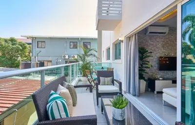 a balcony with chairs and a television on a building at YOUR SPACE IN SANTO DOMINGO Gazcue in Colorado