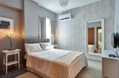 a bedroom with a large bed and a mirror at YOUR SPACE IN SANTO DOMINGO Gazcue in Colorado