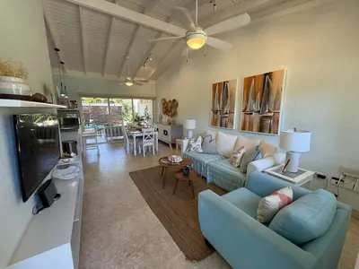 a living room with a blue couch and a tv at 2BR Juan Dolió House in Juan Dolio
