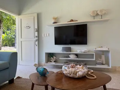 a living room with a tv and a table at 2BR Juan Dolió House in Juan Dolio