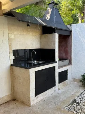 a kitchen with a sink and a black counter top at 2BR Juan Dolió House in Juan Dolio