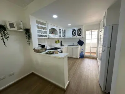 a kitchen with white cabinets and a refrigerator at The best place to rest, Arenas del Caribe in Punta Cana