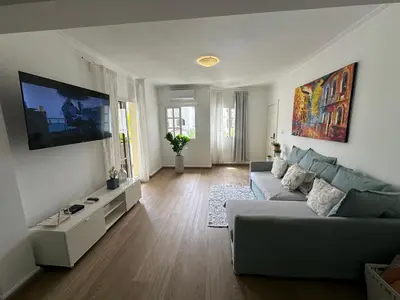 a living room with a couch and a flat screen tv at The best place to rest, Arenas del Caribe in Punta Cana