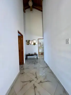 a living room with a marble floor and a table at Sosua Residence by CJDR in Sosúa