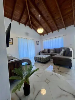 a living room with a couch and a table at Sosua Residence by CJDR in Sosúa