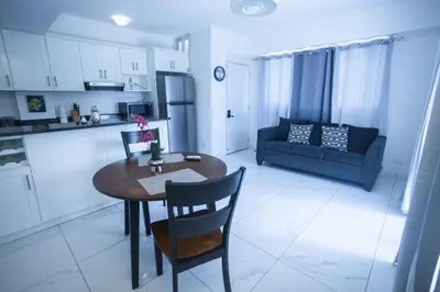 a kitchen and living room with a table and a couch at Sosua Residence by CJDR in Sosúa