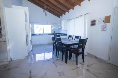a kitchen with a table and chairs in a room at Sosua Residence by CJDR in Sosúa